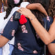 Supporters od Kamala Harris embrace.